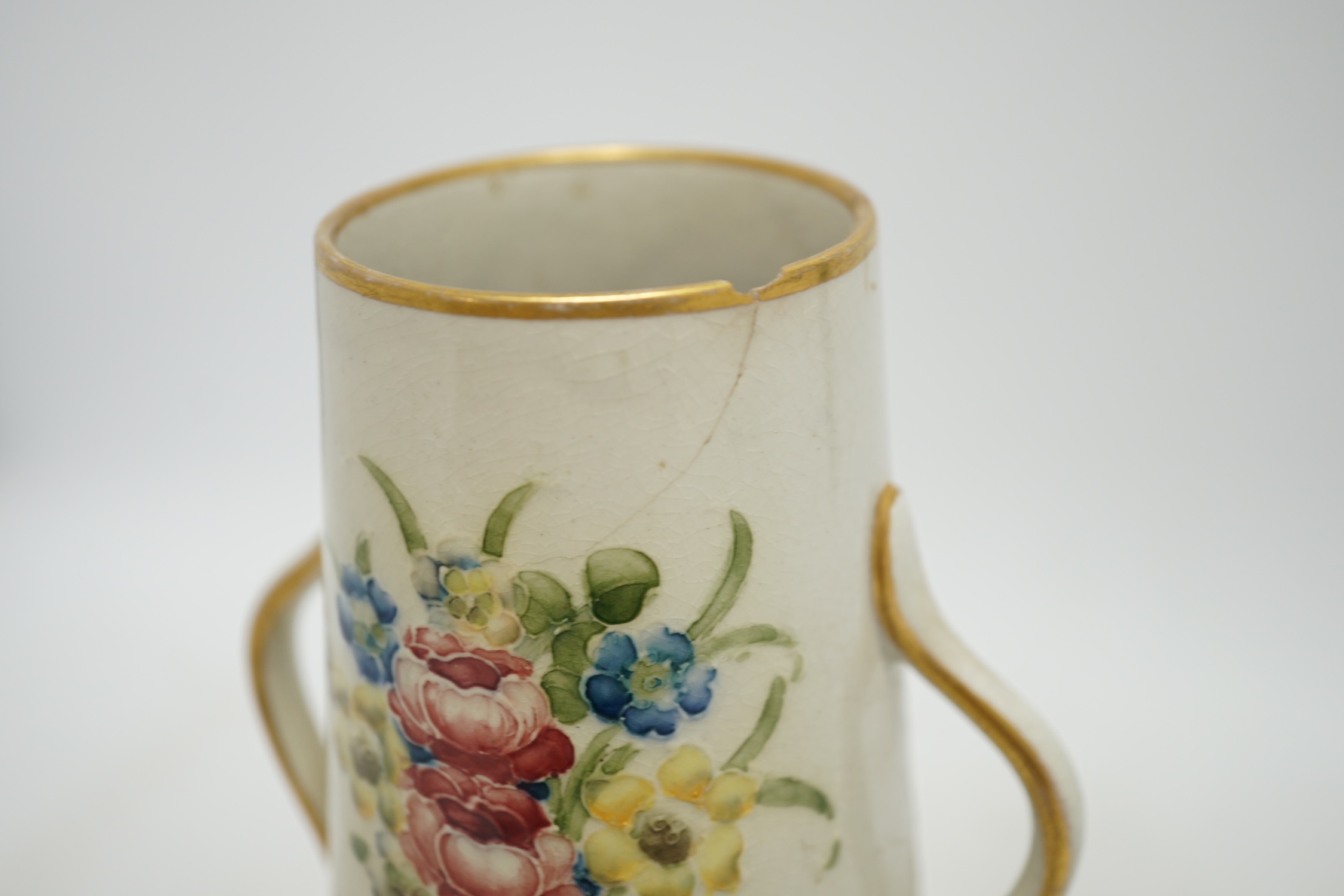 A Moorcroft for McIntyre Florian Ware two handled vase, circa 1905, height 20cm. Condition - large chip and crack to top rim